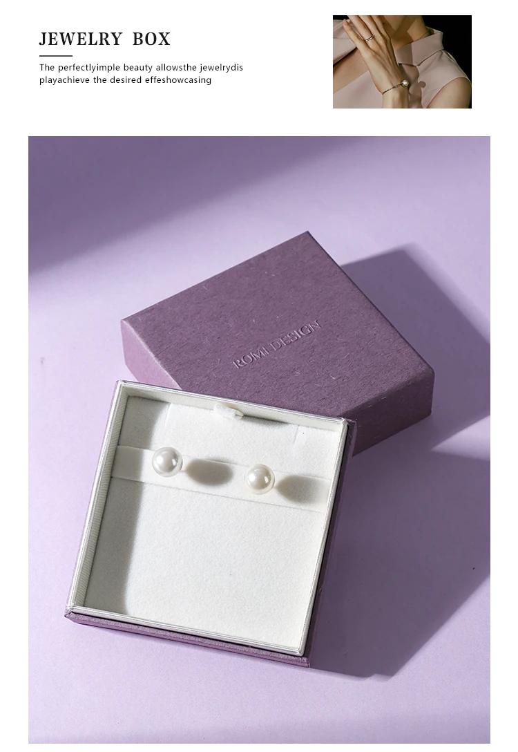 Custom purple jewelry box earring lifestyle romi — pearl earring on white velvet interior with ROMI DESIGN logo. Custom jewelry boxes with velvet interior for jewelry brands, jewelry packaging manufacturer.
