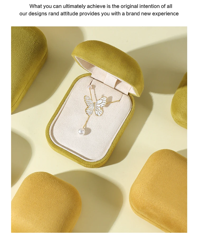 ALT TEXT 168 CHARS Custom suede jewelry box with butterfly crystal pearl necklace — yellow velvet round-corner case in soft gift scene. ROMI minimalist jewelry packaging for boutique brands. Copy